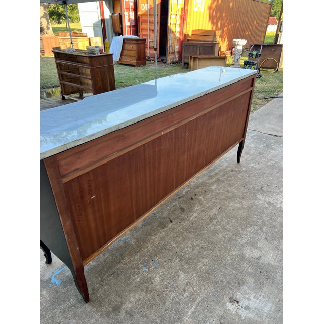 French 19th Century Louis XV Sideboard, crafted in richly figured mahogany veneer with ebonized wood framing, topped with...