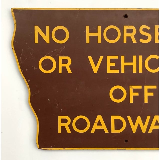 Vintage one sided shaped road sign from Iowa in brown background with gold lettering and border. Sign has wear from use,...