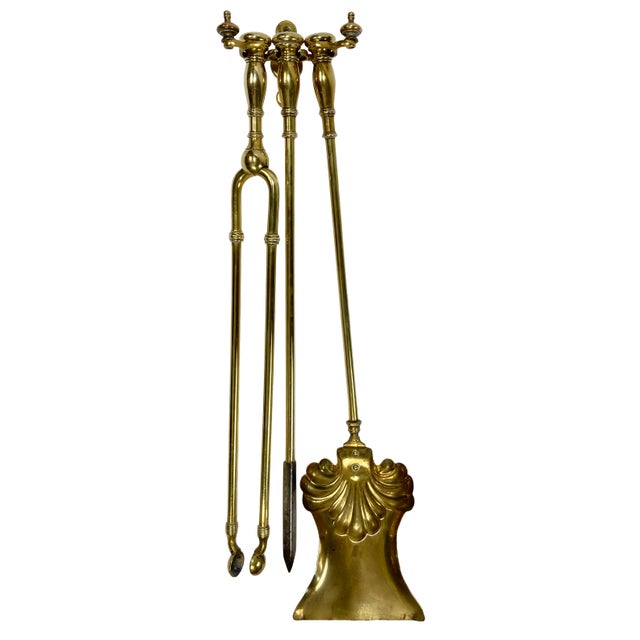 Rare set of vintage decorative brass wall mount fireplace tools. Three ornate tools (tongs, poker, shovel) hang from three...