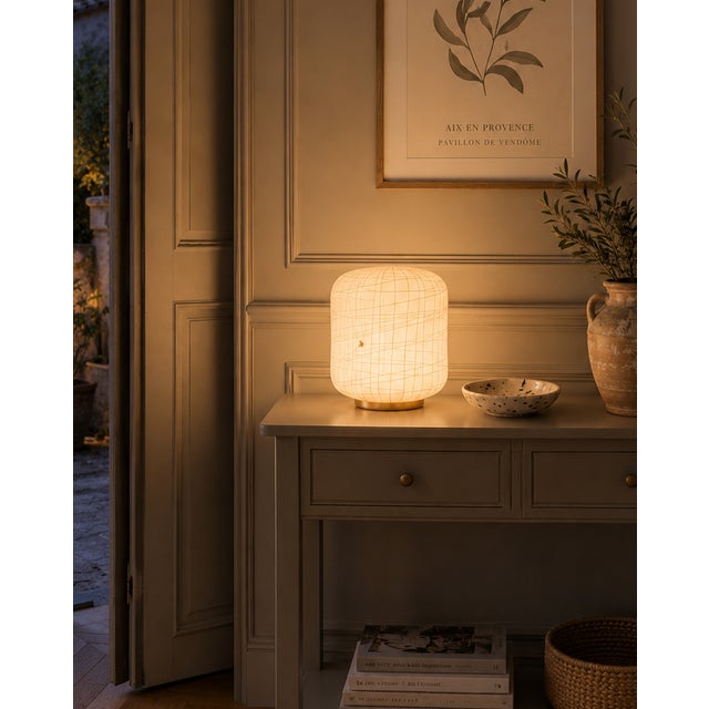 The exquisite peonia table lamp by la murrina murano is crafted from cream-colored glass with white filigree. The master...