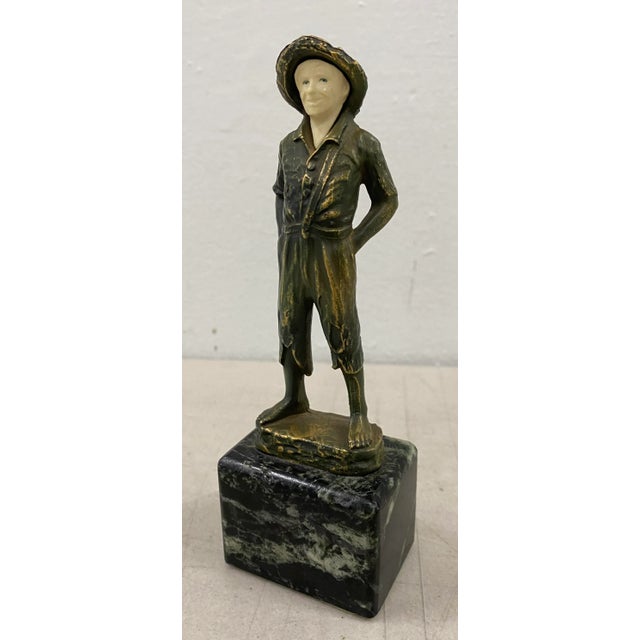 John Ruhl (American, 1873-1940) Gilded Spelter Figurine of a Young Boy on Marble Base c.1920 The young boy is mounted on...
