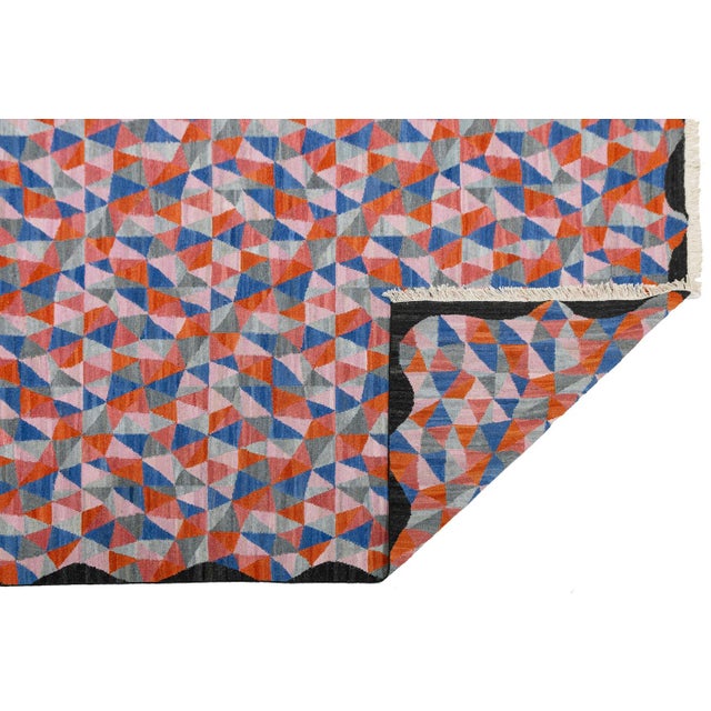 Laura Gottwald's Apadana Collection Fantasia features an exuberant design of asymmetrical triangles in vibrant colors....