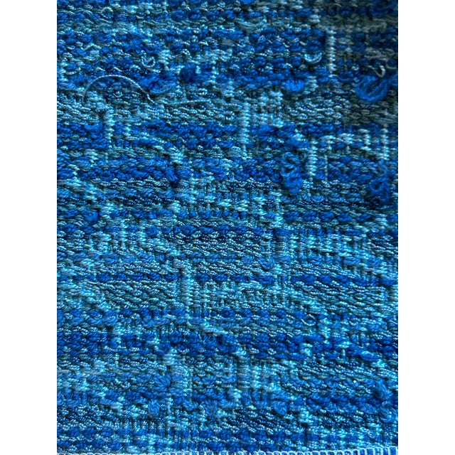 Inspired by the rhythmic beauty of the sea, this blue Schumacher fabric features a subtly scalloped pattern that evokes...