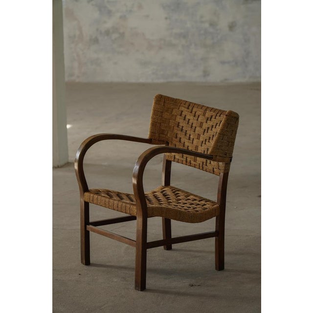 Sculptural armchair often attributed to German designer Erich Dieckmann, one of the notable figures associated with the...