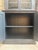 This antique two-piece pine sideboard captivates with its clean, timeless lines. Its deep black patina highlights its...