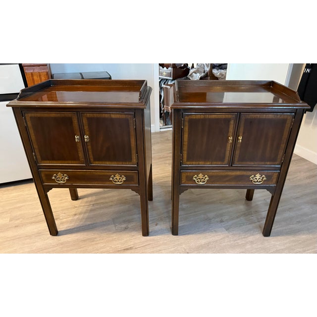 A beautiful pair of vintage Drexel mahogany nightstands featuring elegant traditional styling, framed panel cabinet doors,...
