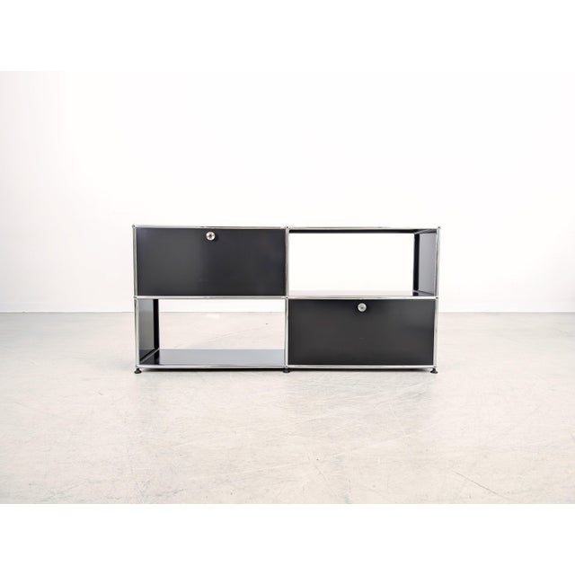 USM Haller sideboard in size 2x2 with two drop-down doors for sale. The sideboard has been professionally cleaned and is...