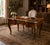 A beautifully crafted French-style writing desk featuring rich marquetry inlay and ornate gilt bronze (ormolu) mounts. The...