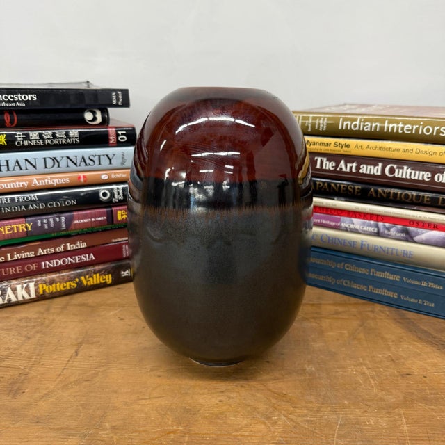 "About This Piece About This Piece A bold statement of contrast, this vase blends deep obsidian tones with the fiery...