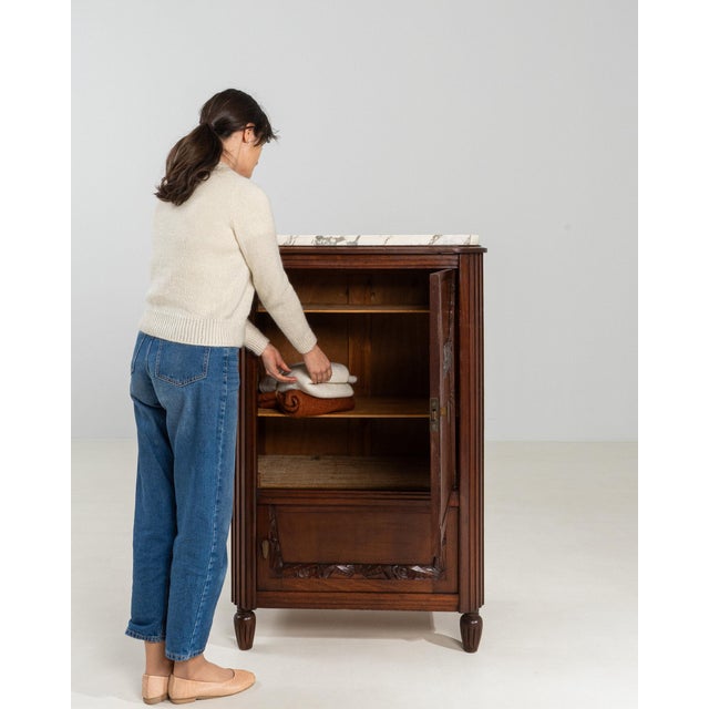 Here is a small cabinet, its dark mahogany, carved shaped door the first thing to catch the eye. Dating to 1910s and...