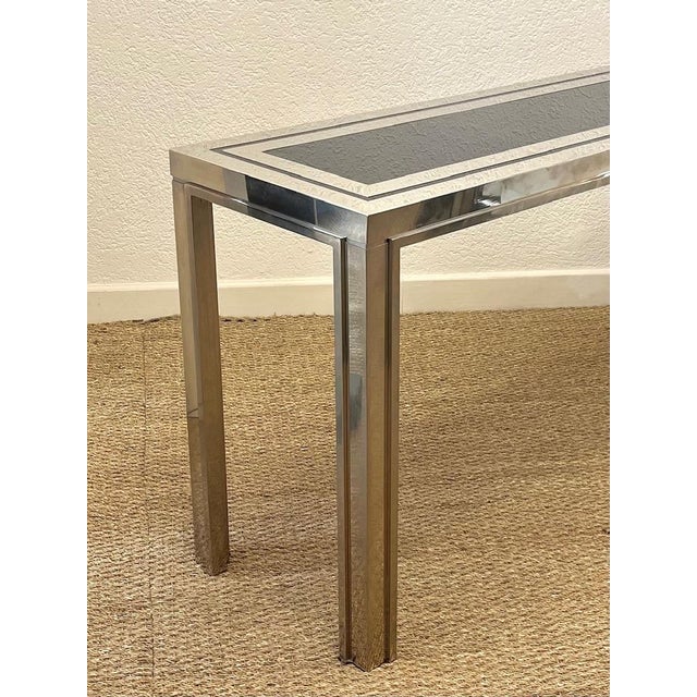 Elegant and large console table in chromed metal and dark blue glass, produced by Liwan's Rome circa 1970s. Good...
