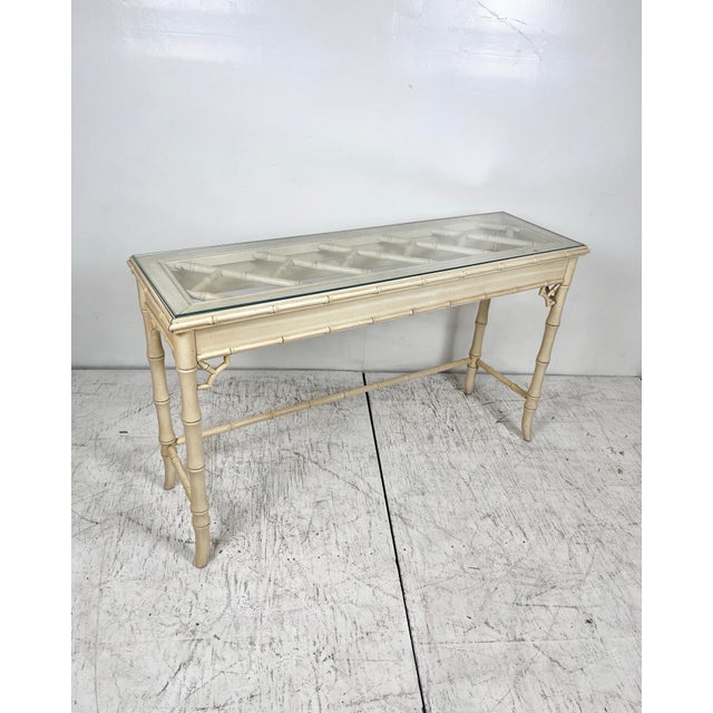Vintage faux bamboo console table. Faux bamboo legs with Chinese chippendale fretwork top. Fretwork on corners with inset...