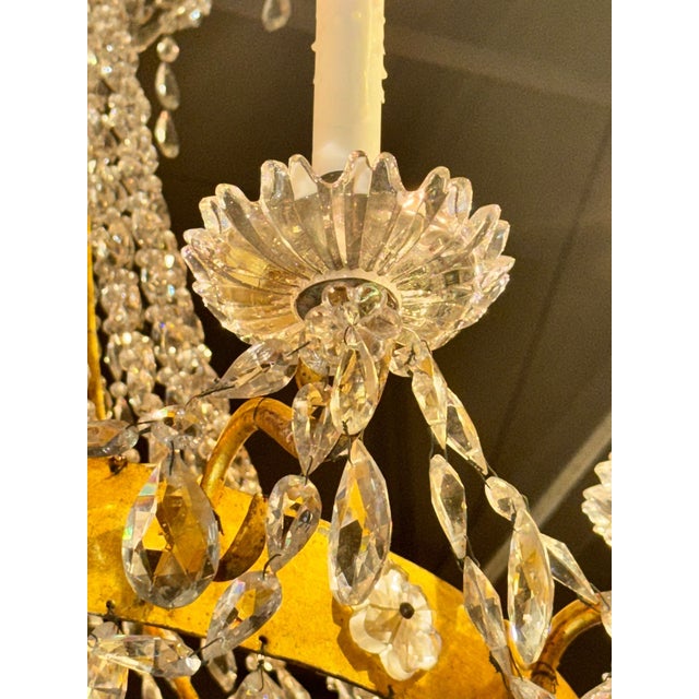 This 19th century Italian Empire gilt tole and crystal chandelier exudes elegance and sophistication. Featuring glistening...