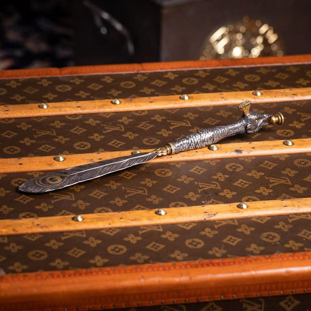 Antique ​20th Century silver plated and brass letter opener designed as a peacock with its tail neatly folded. A...