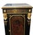 A striking 19th century French Boulle-style cabinet crafted in ebonized wood with elaborate gilt bronze mounts and a white...