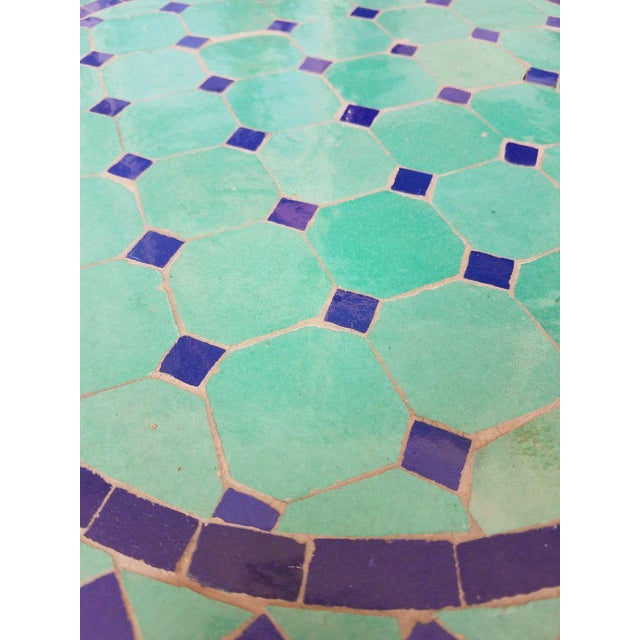 100 % glazed. Round shape. Blue and turquoise Moroccan mosaic table measuring approximately 24" in diameter. For both...