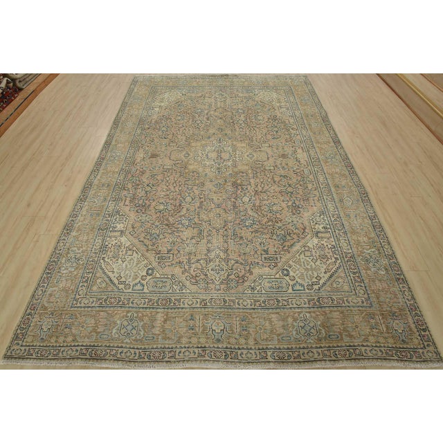 An authentic vintage traditional Tabriz rug hand-knotted with fine wool and natural dyes. This oriental rug features a...