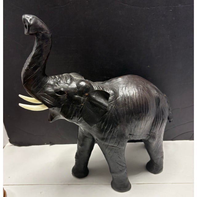 Vintage hand-crafted leather elephant figurine with raised trunk for good luck. Large decorative size with rich black...