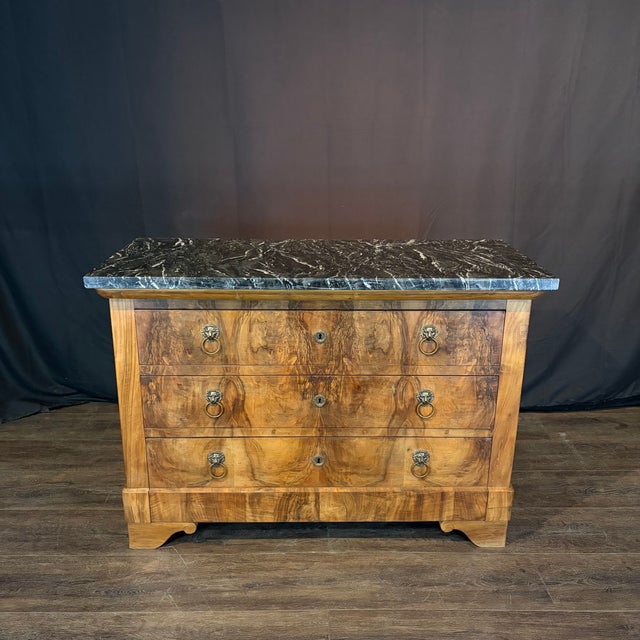Elegant 19th century French three-drawer commode, dresser or chest of drawers featuring a richly figured burled wood...