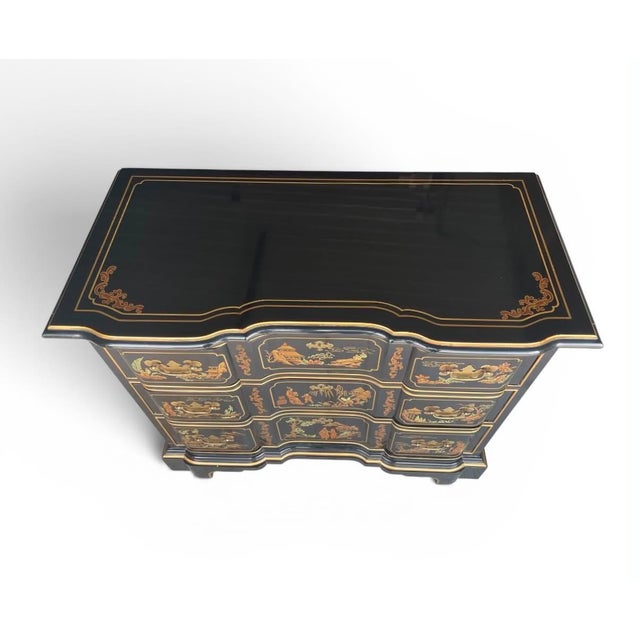 Elegant black paint and high releif, intricate gold landscape scenes, this Asian-inspired Drexel dresser offers both...