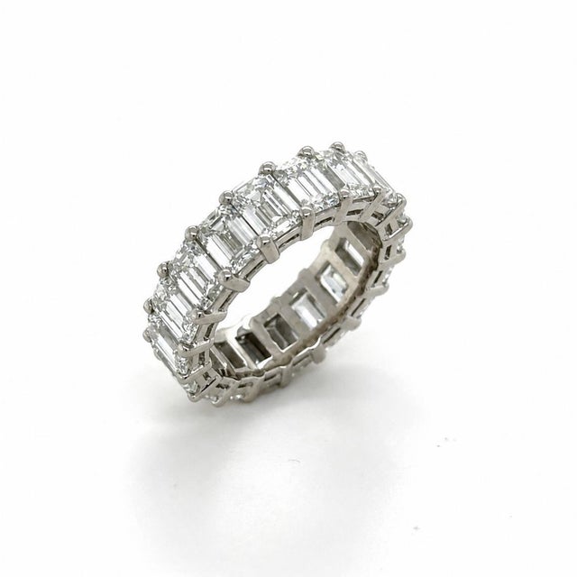 An extraordinary diamond eternity band featuring 39 emerald-cut diamonds weighing an impressive 9.12 carats total....