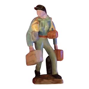 Continental French Art Deco Porcelain Figure of a Traveling Salesman Carrying Suitcases and Wearing a Jockey Cap
