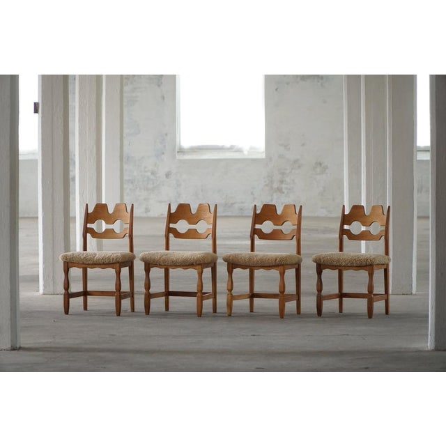 A beautiful and sculptural set of 10 oak dining chairs designed by Henning (Henry) Kjærnulf for Nyrup Møbelfabrik,...