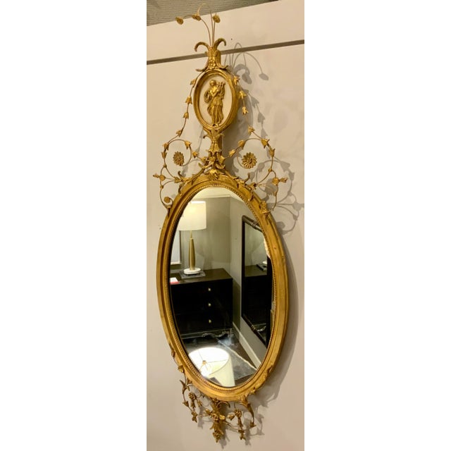 Timeless Vintage Decorative Arts Oval Carved Gold New York Wall Mirror, circa 1990’s