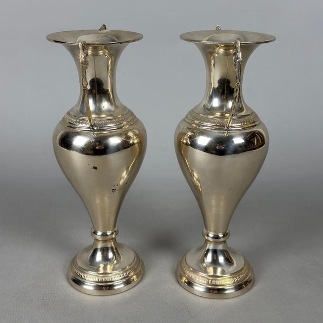A rare and exquisite pair of solid silver amphorae, a true treasure of goldsmith craftsmanship, perfect for enhancing the...