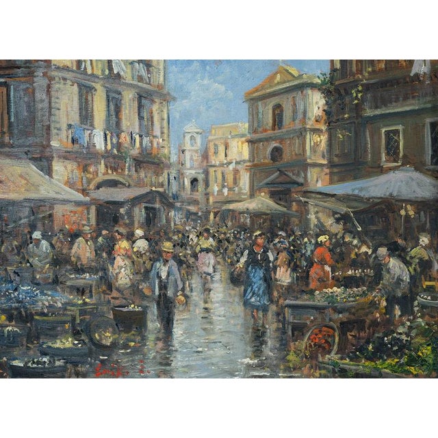 An antique oil painting on wood depicting a market square in Naples from the early 20th century. The scene depicts an...