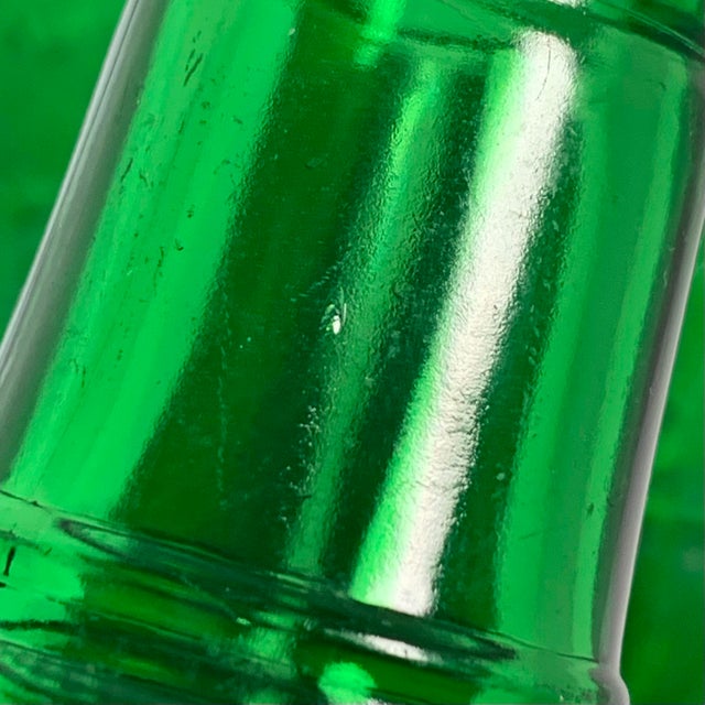 This set of four ribbed green glass soda bottles was produced for Schille Beverages of Columbus, Ohio, around the late...