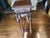 This is a carved mahogany pedestal plant stand, styled closely after classical English revival or Victorian furniture...