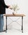 An authentic French bistro table combining a sturdy cast iron base with a warm oak top. The contrast of materials creates...