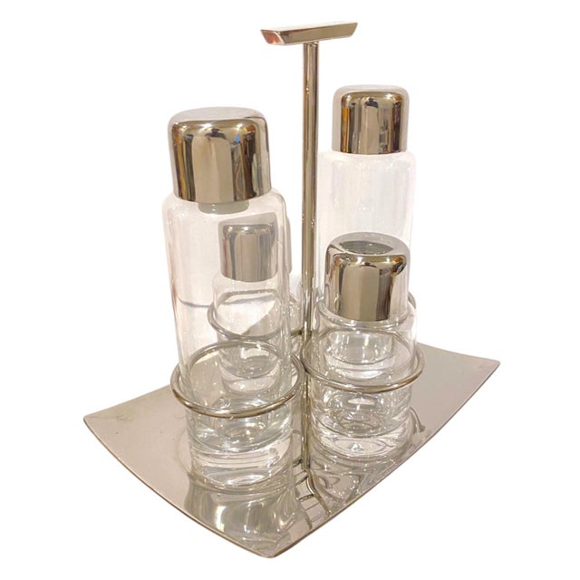 A sophisticated and modern Sambonet Linea Q condiment set made of 18/10 stainless steel and glass. Linea Q is...