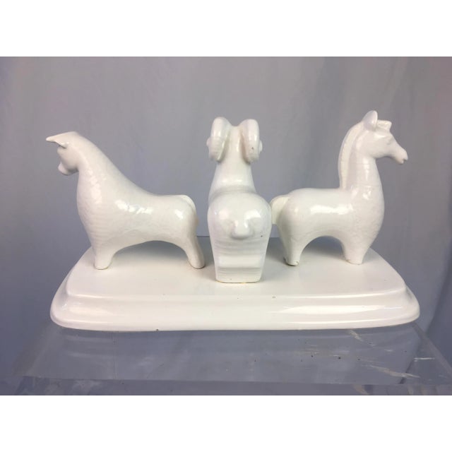 This is an interesting sculpture in ceramic depicting three animals. Very Mid-Century modern in feel, crisp white color