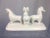 This is an interesting sculpture in ceramic depicting three animals. Very Mid-Century modern in feel, crisp white color