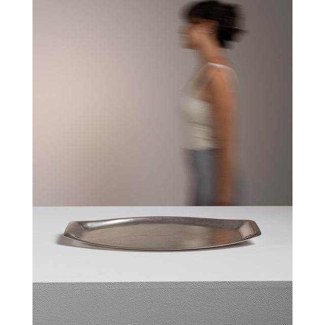 This 20th century silver-plated tray from France is finished in brushed silver plate with a slender, organic outline. The...
