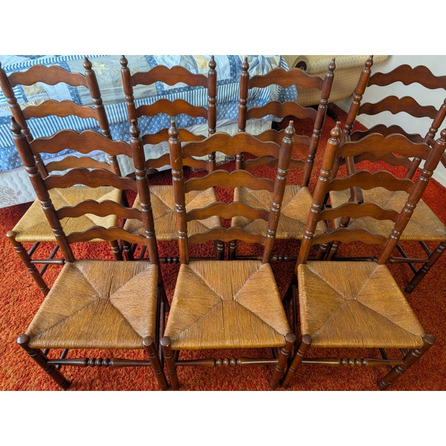This set of seven vintage Tell City Chair Company chairs from Indiana, circa 1924-1943, features seven tall ladder-back...