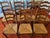 This set of seven vintage Tell City Chair Company chairs from Indiana, circa 1924-1943, features seven tall ladder-back...