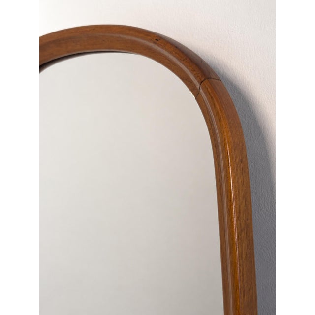 An elegant Swedish Modern wall mirror crafted in teak, distinguished by its tall, slender proportions and softly rounded...