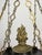 An Empire-style, black and gold chandelier made in Sweden circa 1830. In a bowl-form with 5 candle-style lights with...