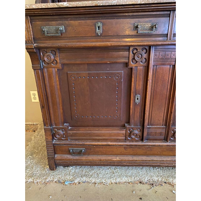Victorian Eastlake Style Walnut Sideboard Buffet dating to the late 19th century(circa 1880-1890. The base has a marble...