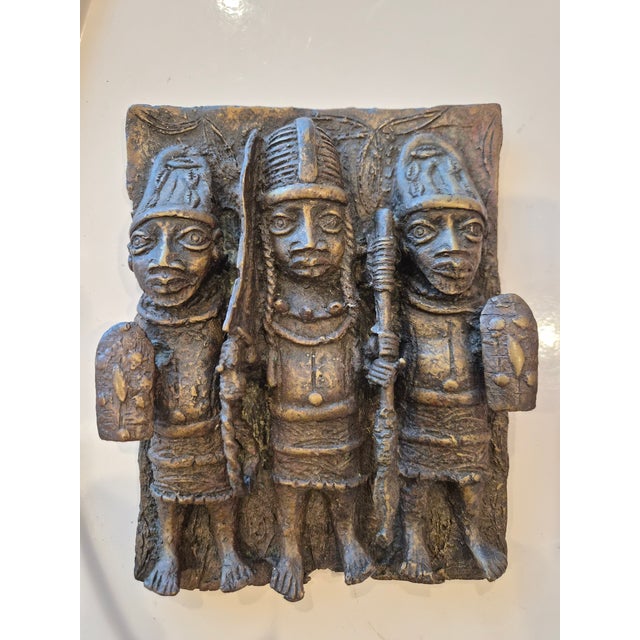 A bronze palace plaque from the Benin Kingdom, 19th Century. This bronze casting is made using a lost wax method. These...