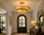 Crafted from solid brass, this handcrafted chandelier features two layered scalloped shades inspired by the graceful form...
