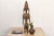 Among the Bamana people of southern Mali, a seated or standing mother figure carrying a child at her waist or back is...