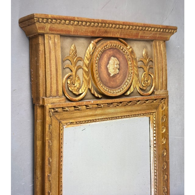 A wooden mirror from around 1860. It is a bronzed mirror with pastel decoration. The colors are very harmonious. The...