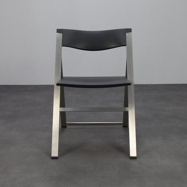 This elegant p08 folding chair by italian brand tecno combines clean modern design with practical usability. The brushed...