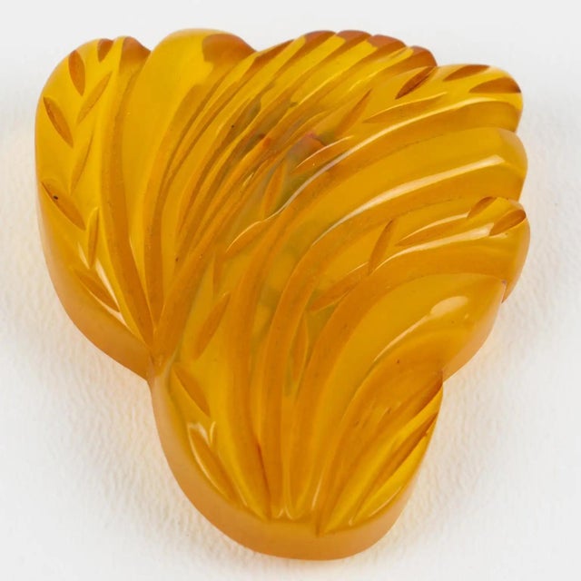 This superb hand-made Bakelite brooch dress clip features a floral design with a deeply carved and dimensional shape. The...