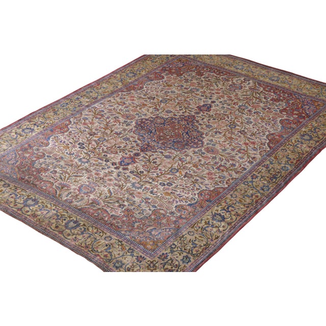 A 7x10 antique Persian rug of Kashan design in a floral medallion style, hand-knotted in silk originating circa 1910-1920....