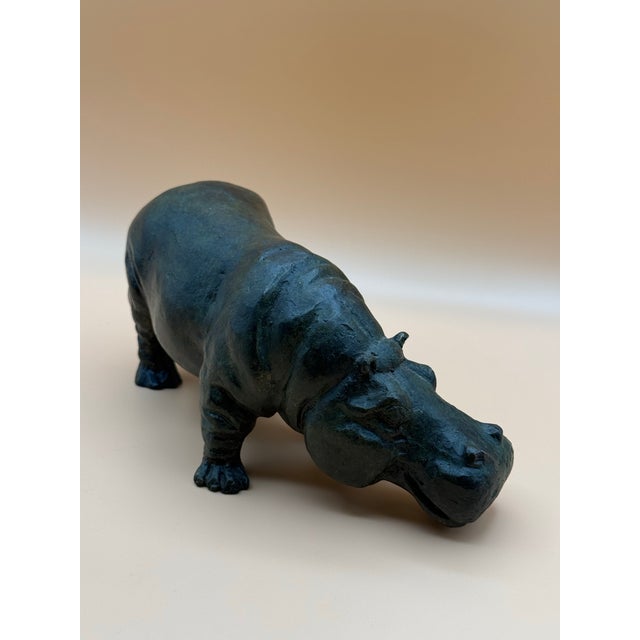 A charming and substantial cast-metal hippopotamus sculpture, beautifully modeled with naturalistic proportions,...